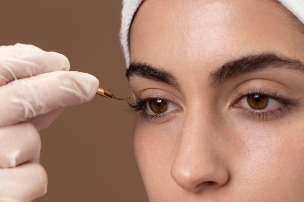 Woman doing an eyelashes treatment to her client