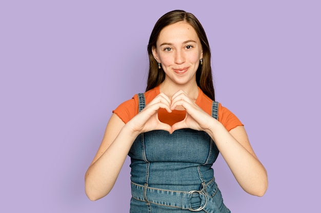 Free photo woman doing heart hands gesture