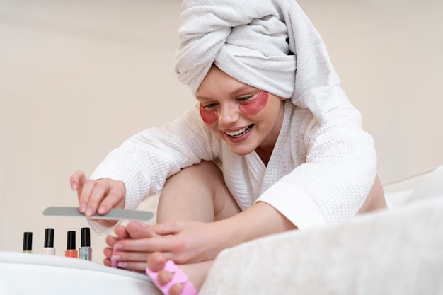 Free photo woman doing her nail care routine