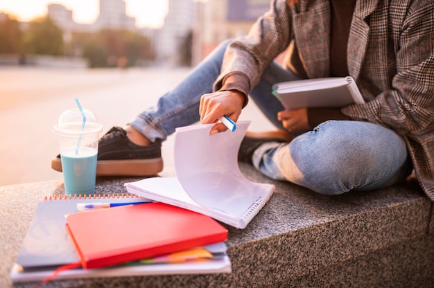 Woman doing homework outdoors in the city