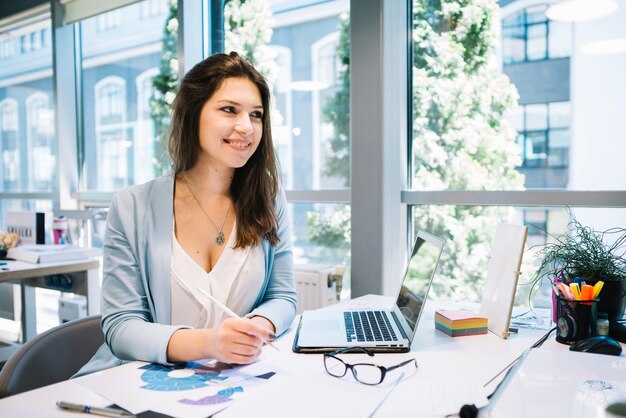 Woman doing paperwork and looking away