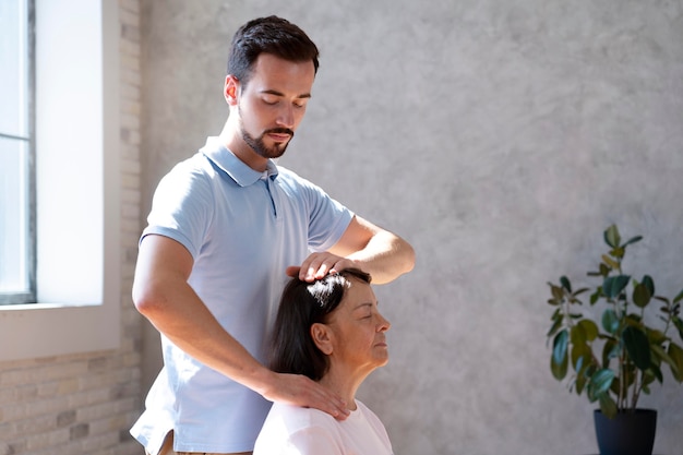 Free photo woman doing physiotherapy for neck close up