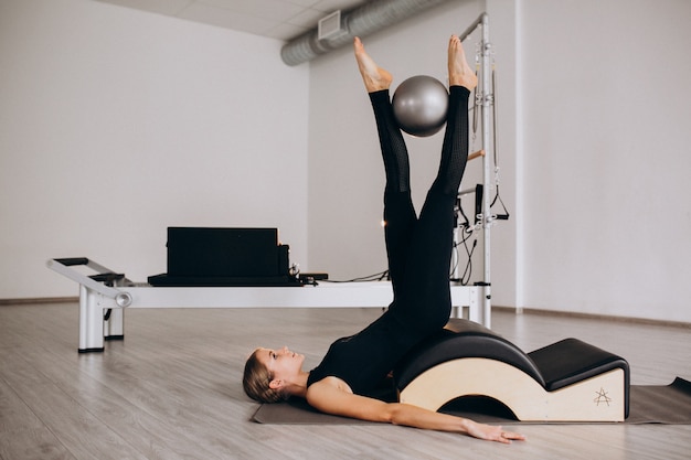 Woman doing pilates with a ball