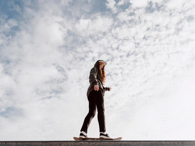 Woman doing skateboard tricks low view