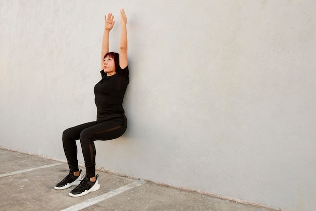 Woman doing wall stand exercise