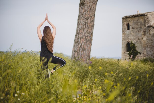 Woman doing yoga at abandoned building