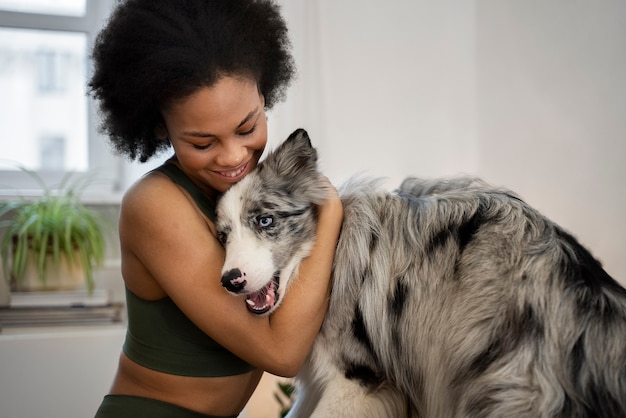 Woman doing yoga accompanied by their pet