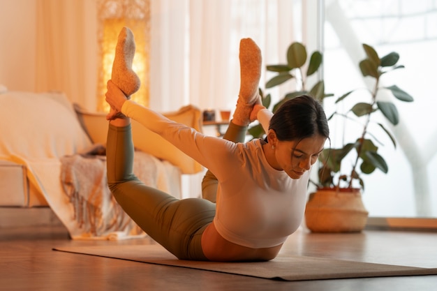Foto gratuita donna che fa yoga in condizioni climatiche fredde e invernali