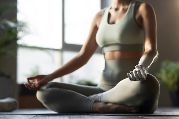 Woman doing yoga indoors side view