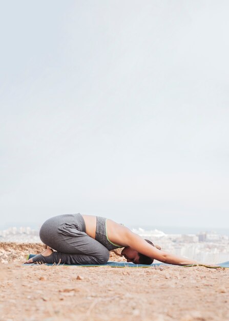 Woman doing yoga meditation exercise outdoors