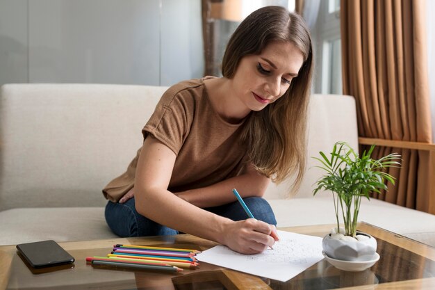 Woman drawing while taking a break from her phone