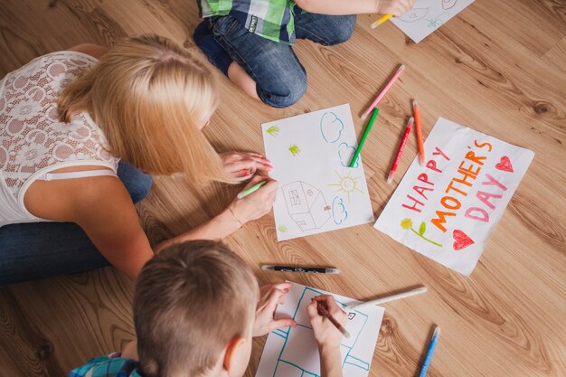 Woman drawing with her children for mother's day