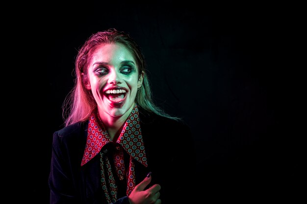 Woman dressed as joker laughing hysterically 