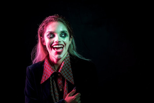 Woman dressed as joker laughing hysterically 