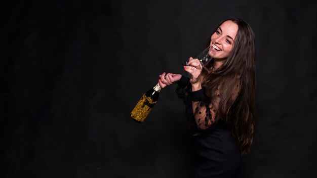 Woman drinking champagne from glass 