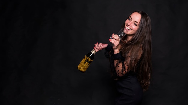 Woman drinking champagne from glass 