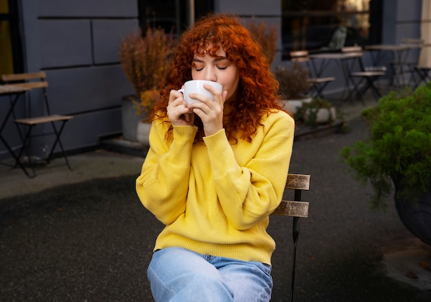 Woman drinking hot chocolate at cafe