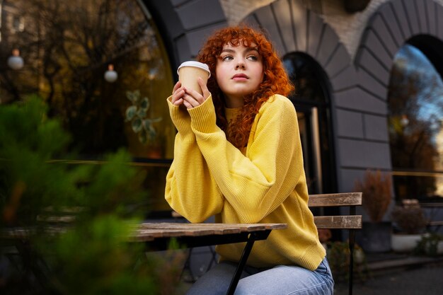 Woman drinking hot chocolate at cafe