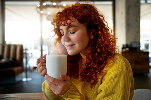 woman drinking hot chocolate at cafe