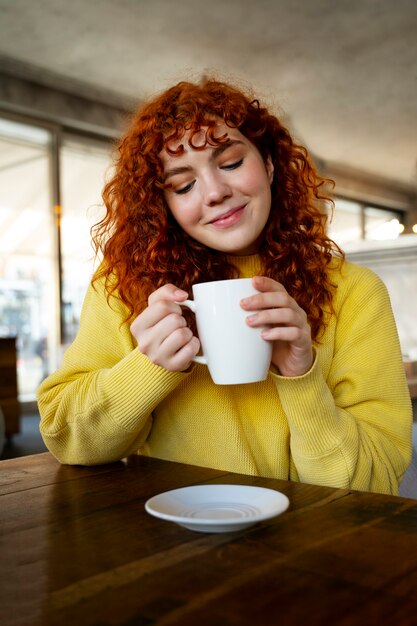 woman drinking hot chocolate at cafe