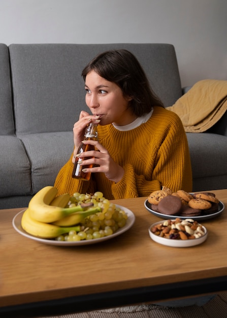 Free photo woman drinking kombucha