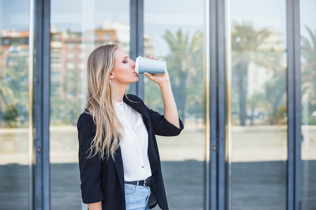 Woman drinking take away coffee at outdoors