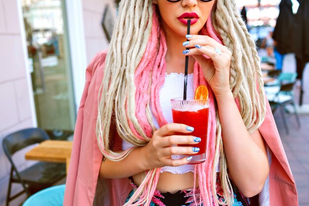 Woman drinking tasty lemonade and relaxing