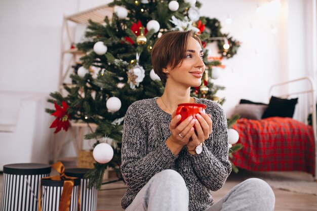 Woman drinking tea on Christmas eve