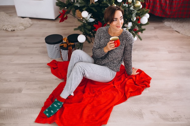 Woman drinking tea on Christmas eve