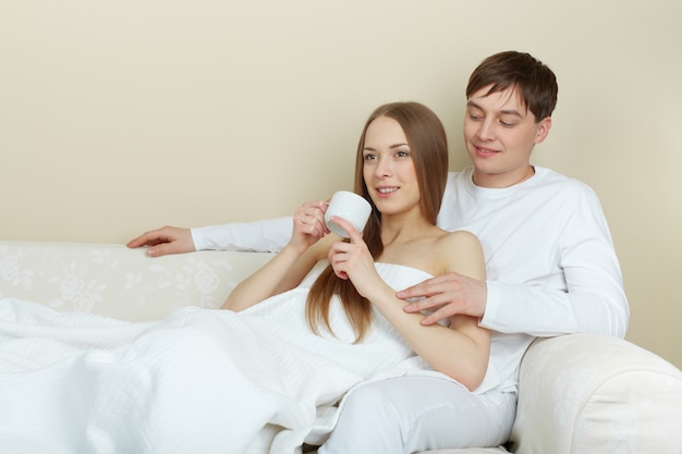 Woman drinking tea with her boyfriend