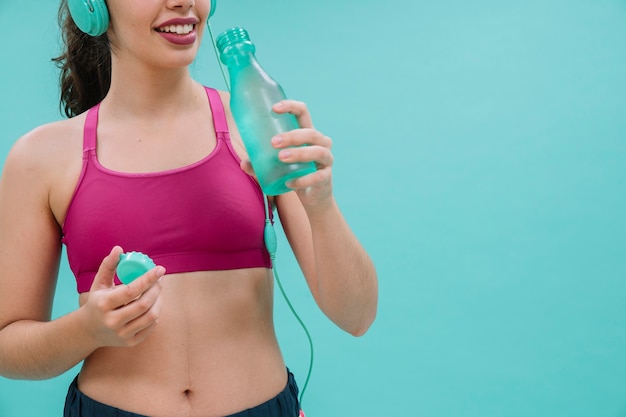 Woman drinking water after training