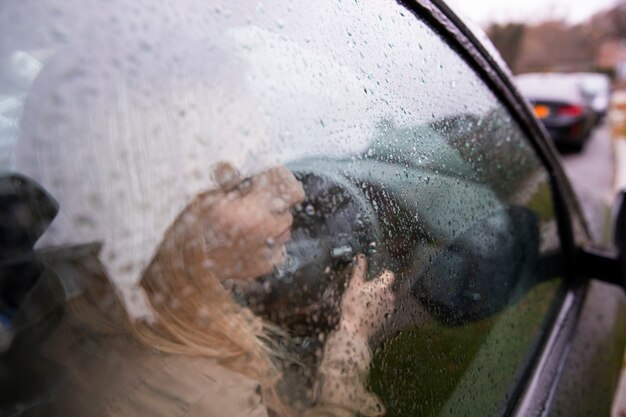 Woman driving in the city while it rains