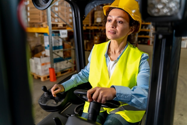 Woman driving warehouse loading machine