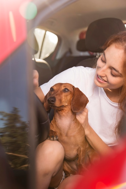 Woman driving with dog close up