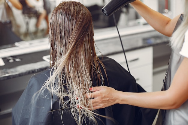 Woman drying hair in a hairsalon