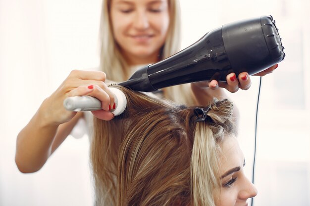 ヘアサロンで髪を乾かす女性