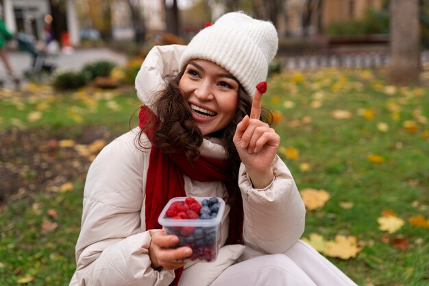 Woman eating berries front view