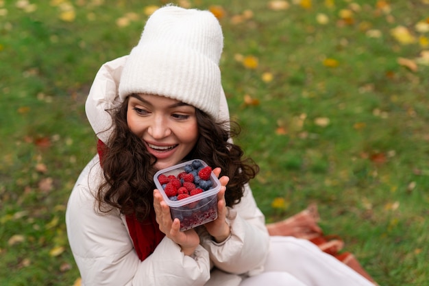 Woman eating berries high angle