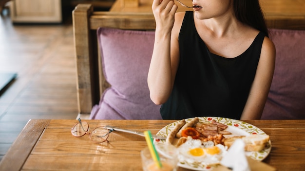 Woman eating breakfast in the restaurant