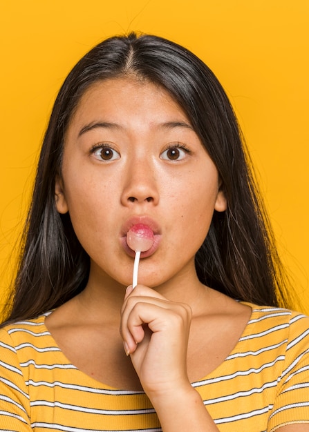 Free photo woman eating a chupa chups