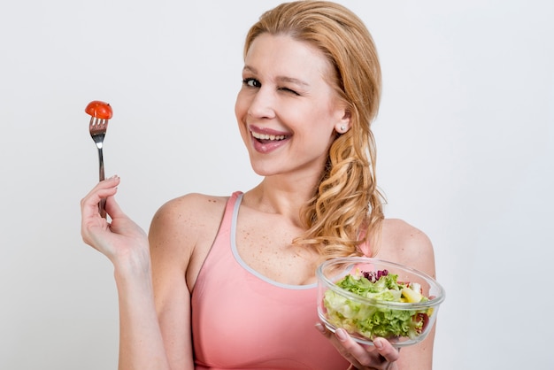 Woman eating a lettuce salad