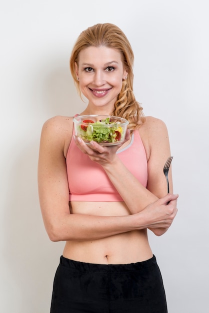 Woman eating a lettuce salad