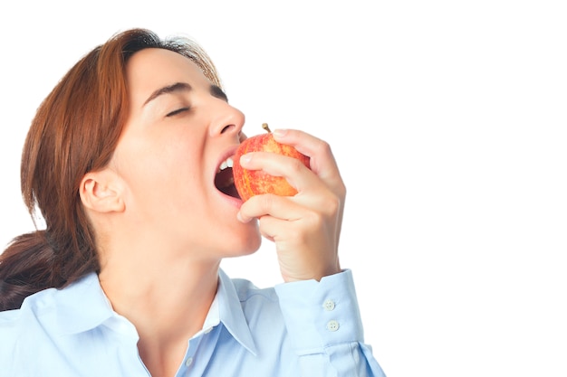 Woman eating red apple