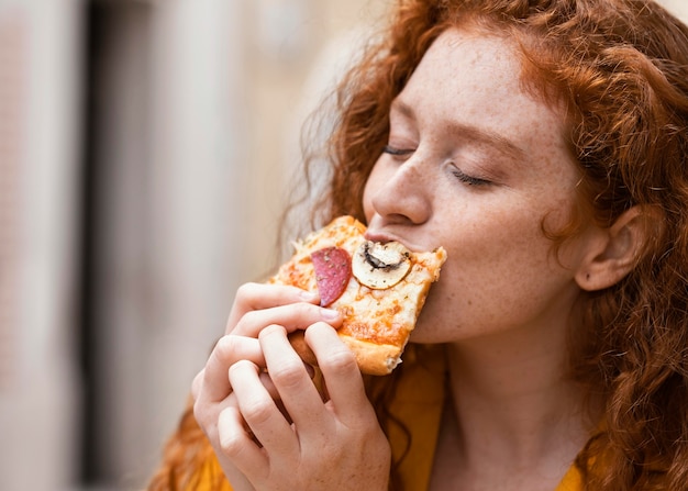 Woman eating street food outdoors