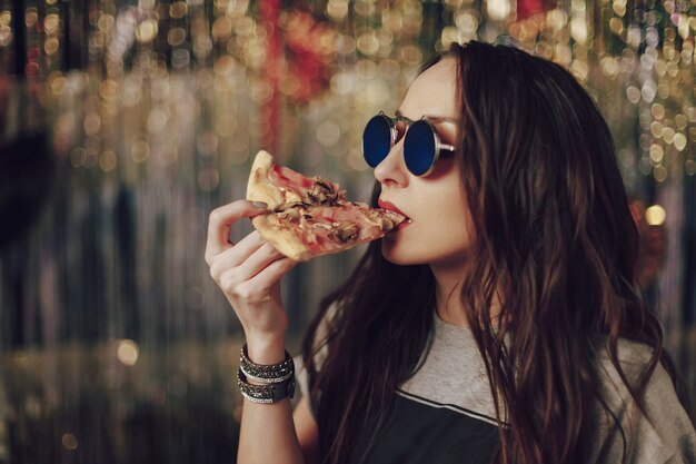 woman eating tasty pizza