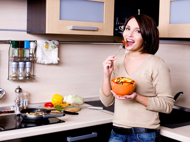 Woman eats the fresh vegetables