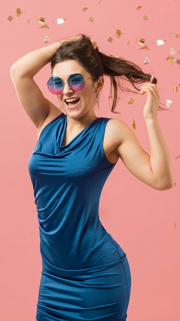 Woman in elegant dress wearing sunglasses at party