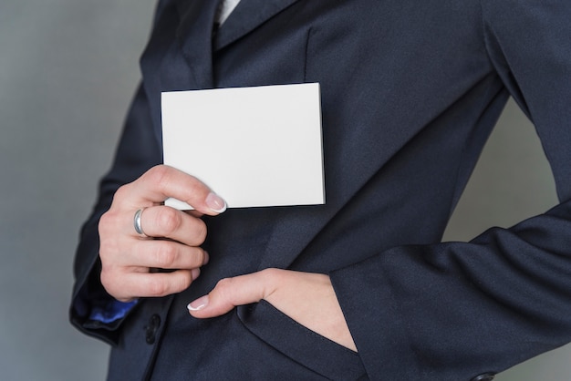 Woman in elegant jacket holding blank paper