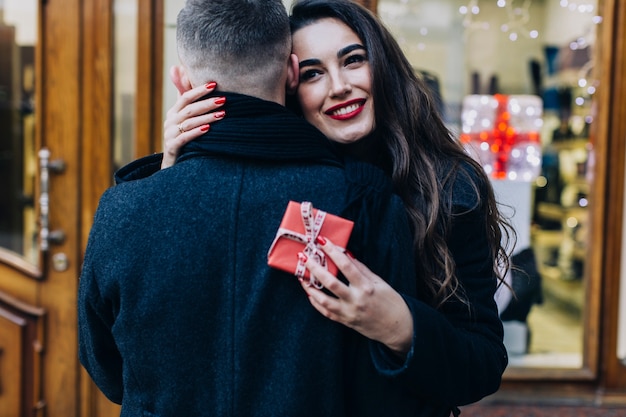 Woman embracing man happy with present
