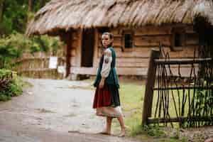 Free photo woman in an embroidered dress walking in the yard